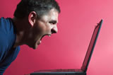 man yelling at laptop