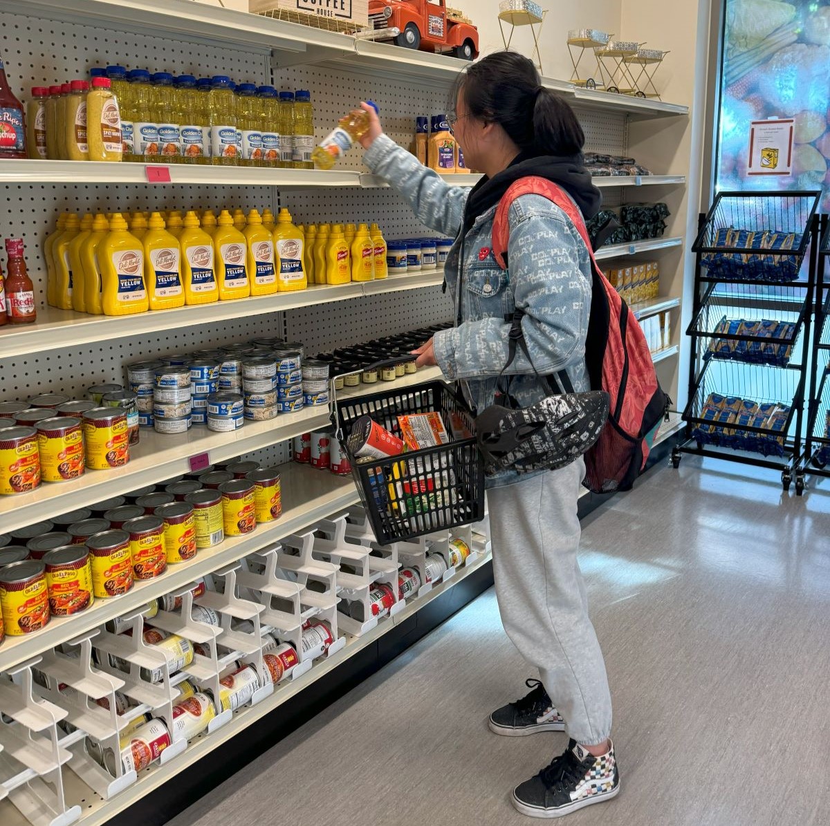 student grabbing groceries from a shelf in the mini market